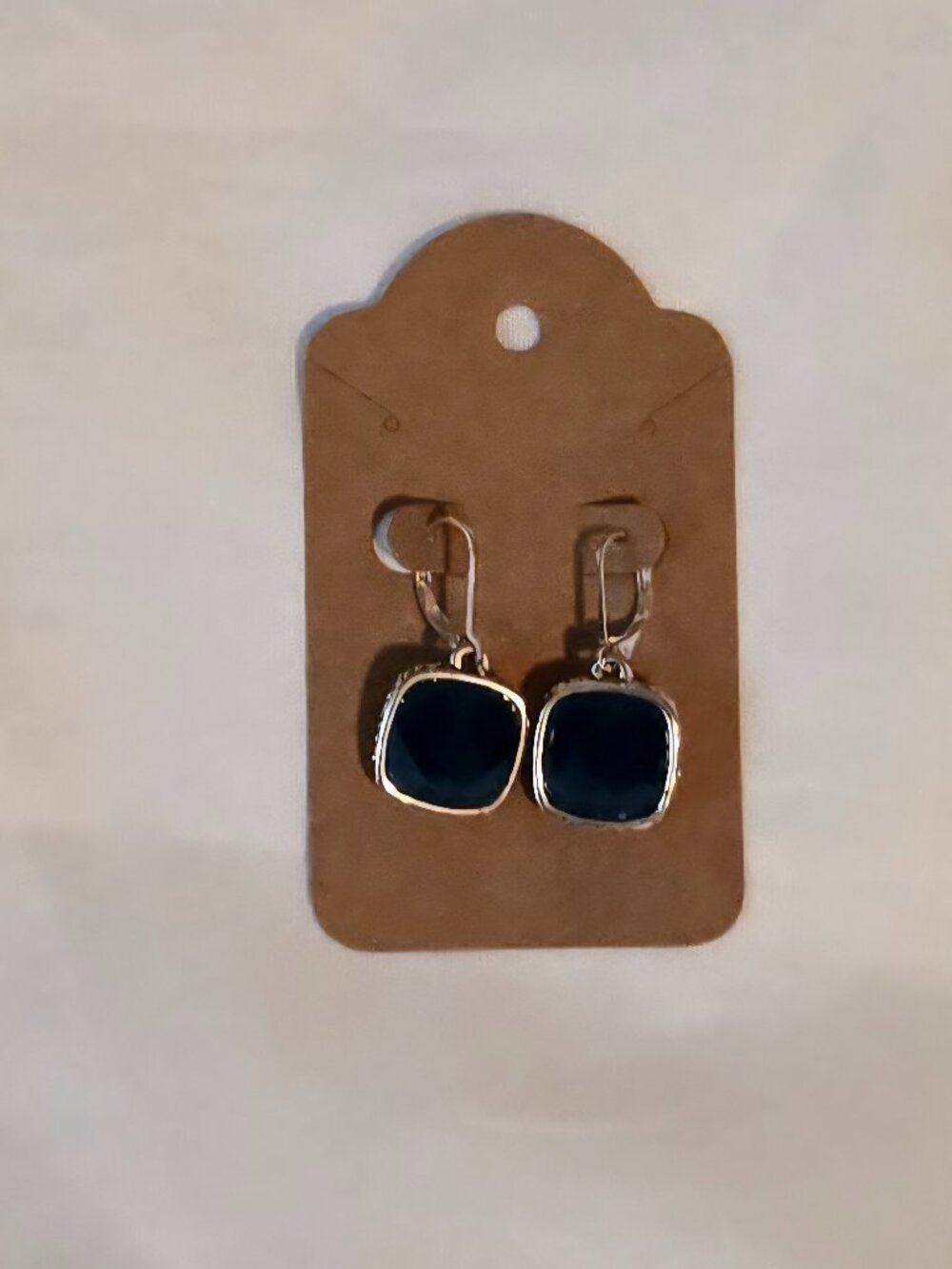 Silver tone earrings with teal blue plastic stone